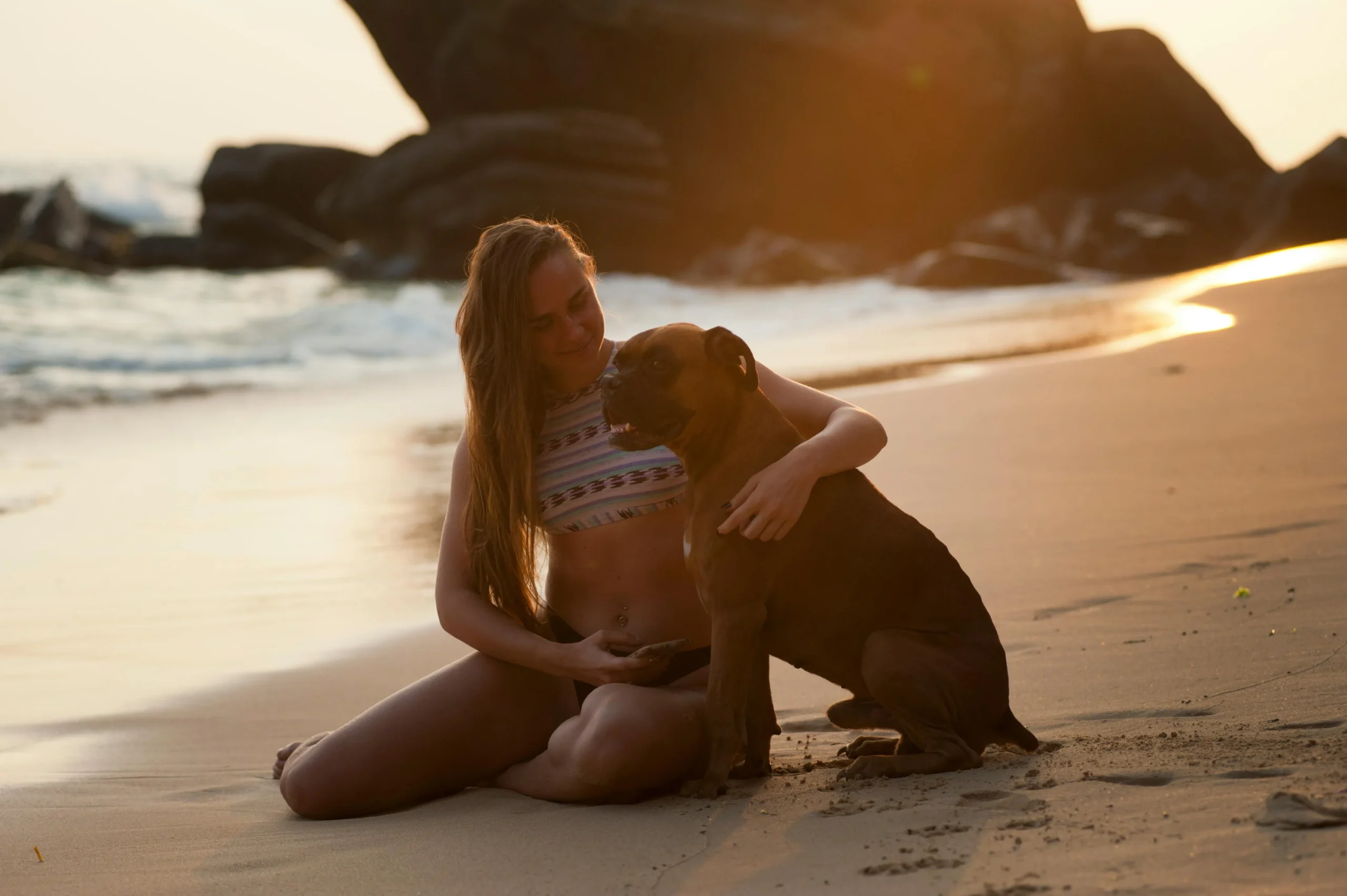 Woman Holding Boxer Dog on Beach Shore Unawatuna